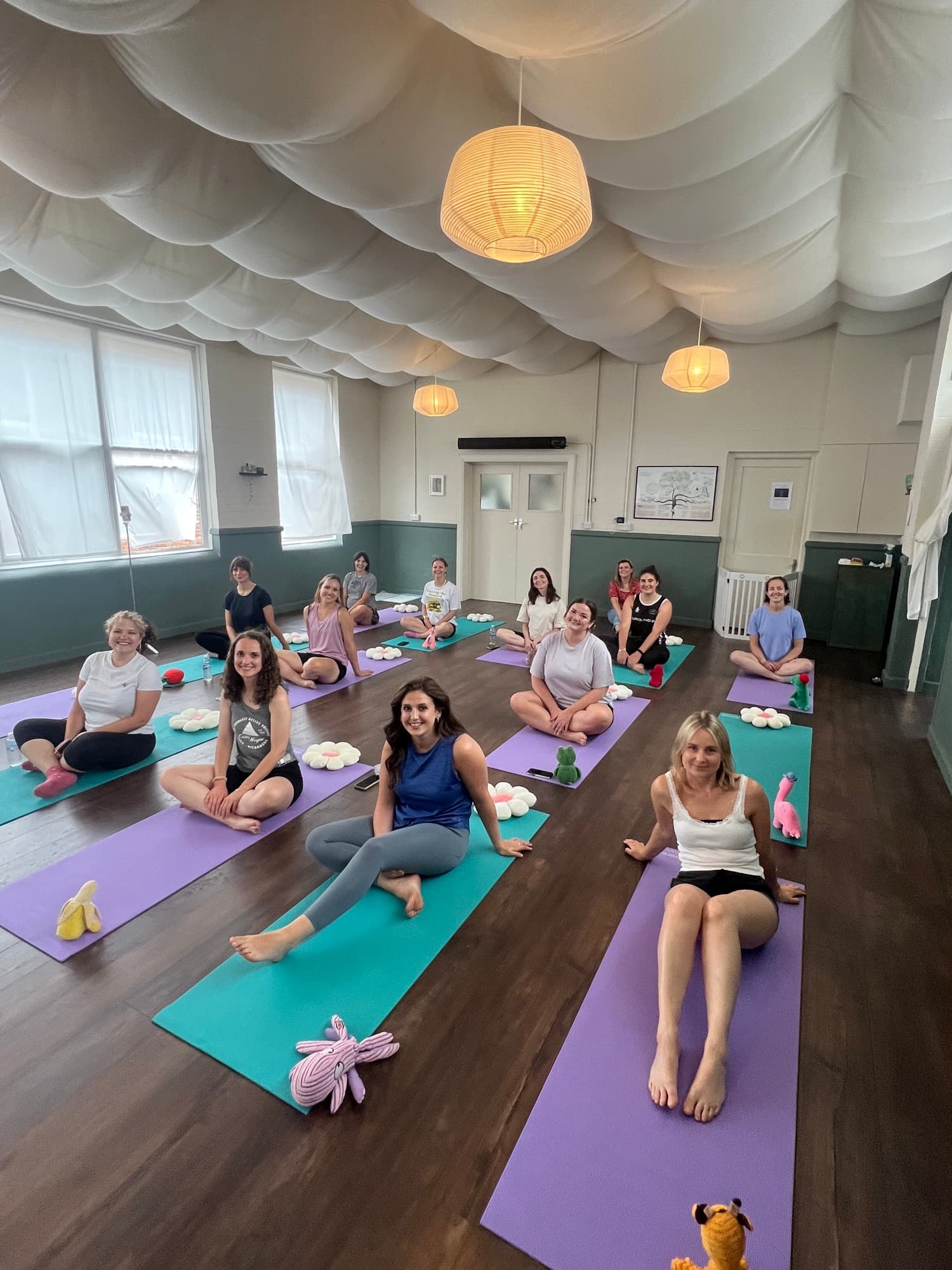 A Yogi Paws class enjoying yoga with the puppies